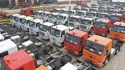 A group of kales trucks parked at the port, waiting for export.